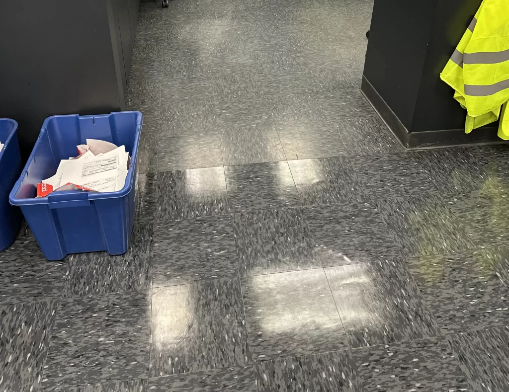 Beautiful shiny tile floor, with small carry box for cleaning tools.