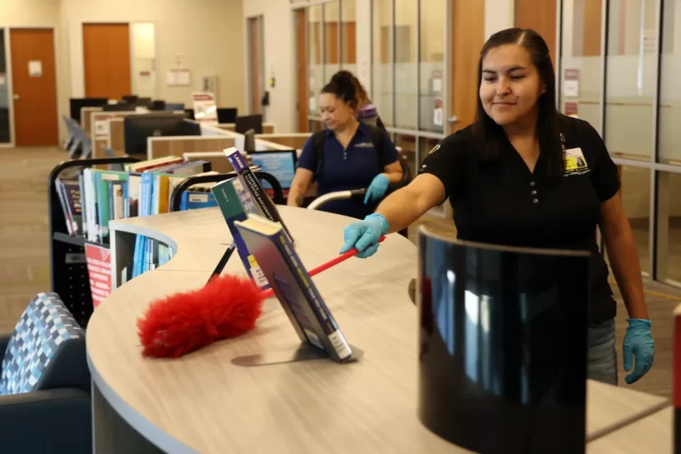 Janitorial Inc. workers cleaning a school library